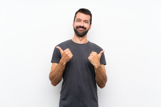 Young handsome man over isolated white wall with thumbs up gesture and smiling