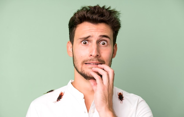 Young handsome man isolated with cockroachs