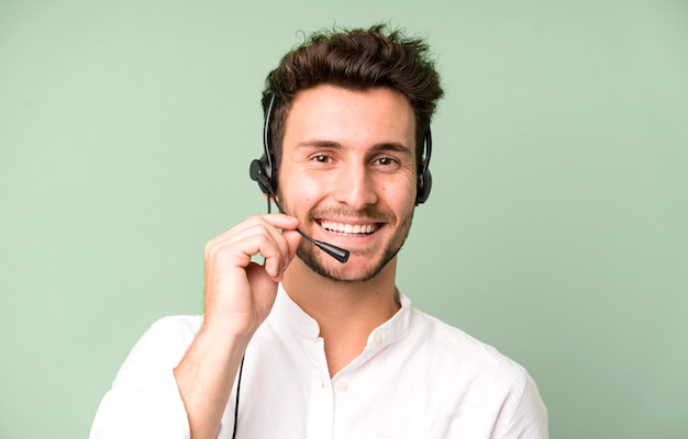 Young handsome man isolated with operator headphones and micro telemarketing concept