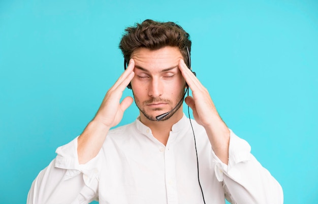 Young handsome man isolated with operator headphones and micro telemarketing concept