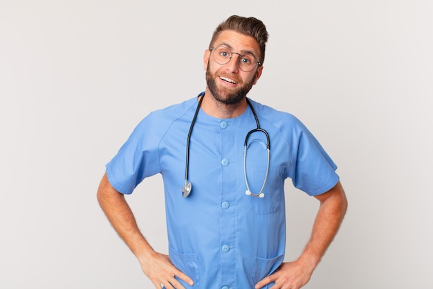 Young handsome man looking happy and pleasantly surprised nurse concept