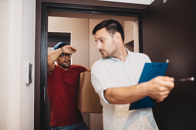 Young handsome man moving into new apartment.