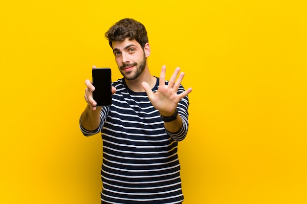 Young handsome man on orange