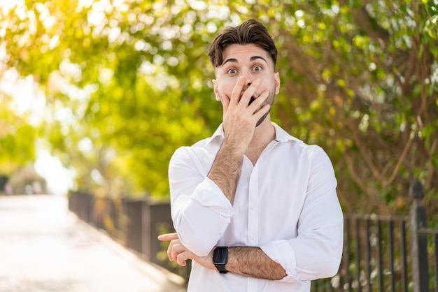 Young handsome man at outdoors surprised and shocked while looking right