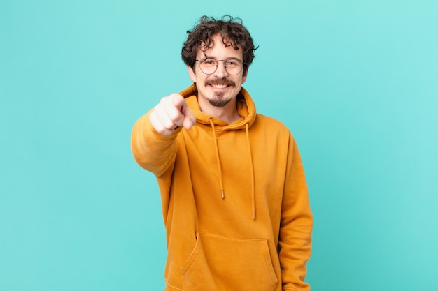 Photo young handsome man pointing at camera choosing you