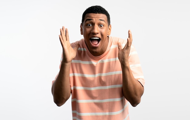 Young handsome man posing over white background afraid and shocked with surprise