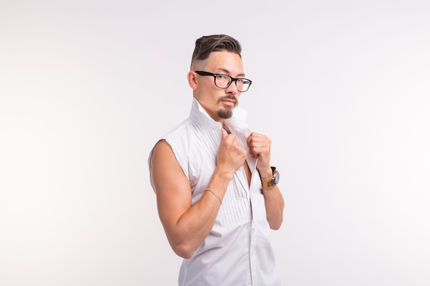 Young handsome man posing in white shirt on white