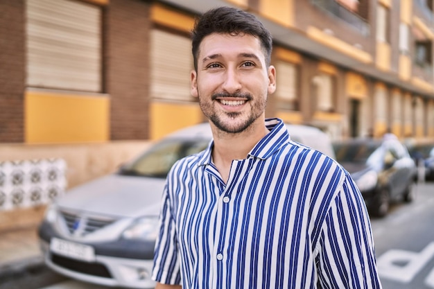 Young handsome man smiling confident at street