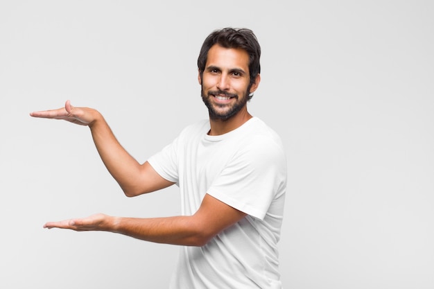 Young handsome man smiling, feeling happy