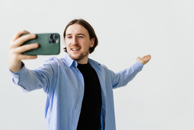 Young handsome man take selfie isolated on white background