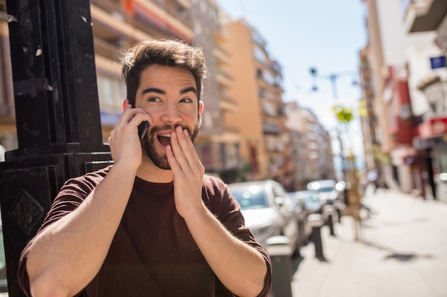 Young handsome man talking on mobile phone