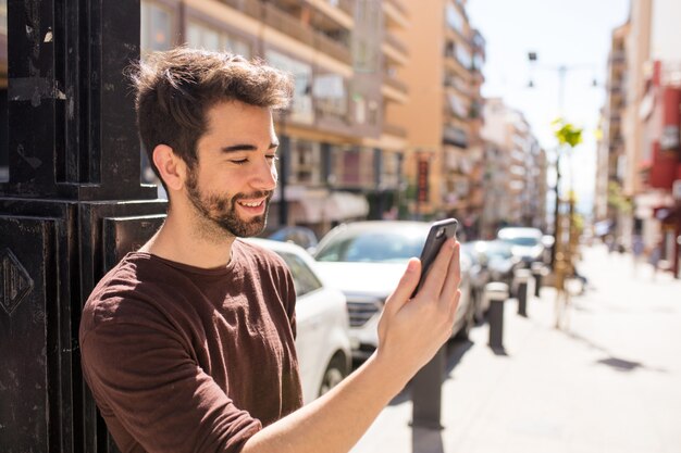 Young handsome man typing a message