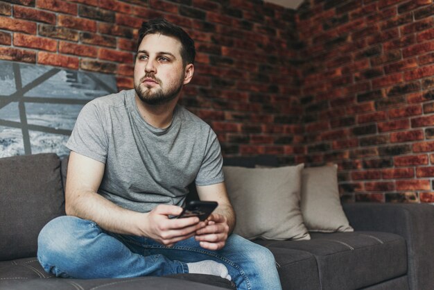 Young handsome man using his smartphone