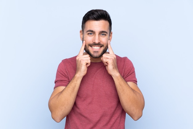 Young handsome man with beard isolated smiling with a happy and pleasant expression