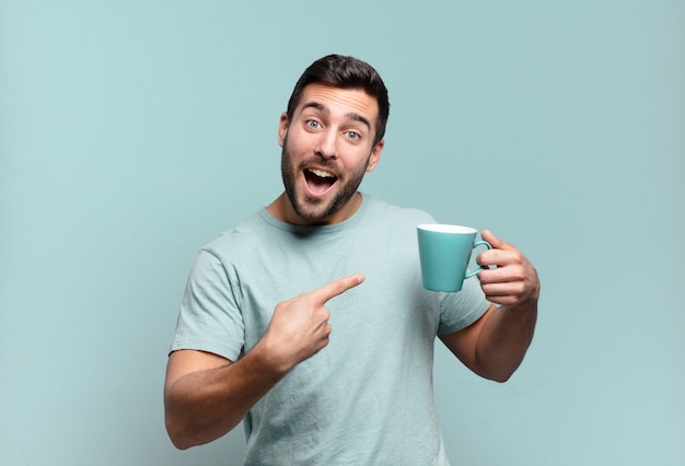 Young handsome man with a coffee cup. breakfast concept