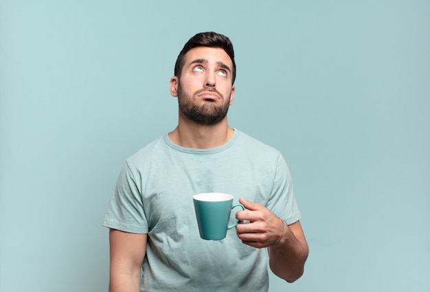 Young handsome man with a coffee cup. breakfast concept