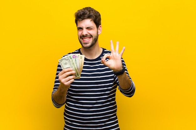 Young handsome man with dollar banknotes