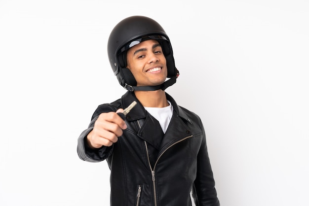 Young handsome man with a motorcycle helmet over isolated white wall