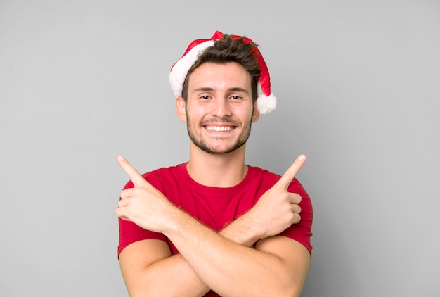 Young handsome man with a santa hat christmas concept