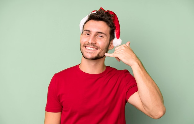 Young handsome man with a santa hat christmas concept