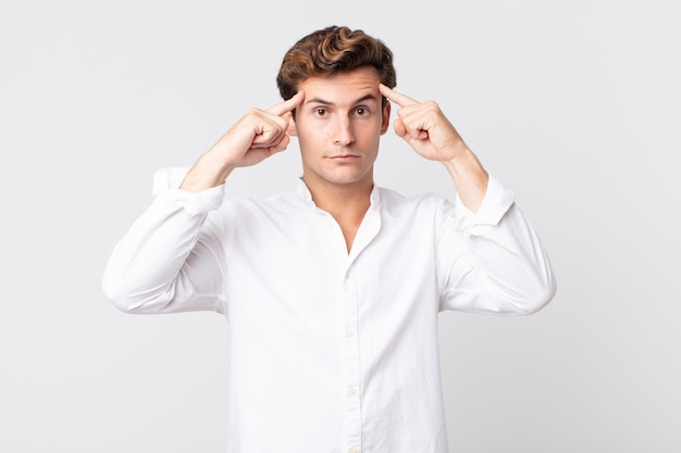 Young handsome man with a serious and concentrated look, brainstorming and thinking about a challenging problem