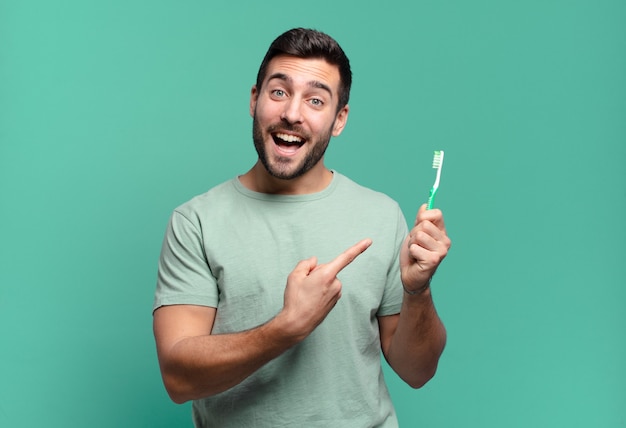 Young handsome man with a teethbrush.