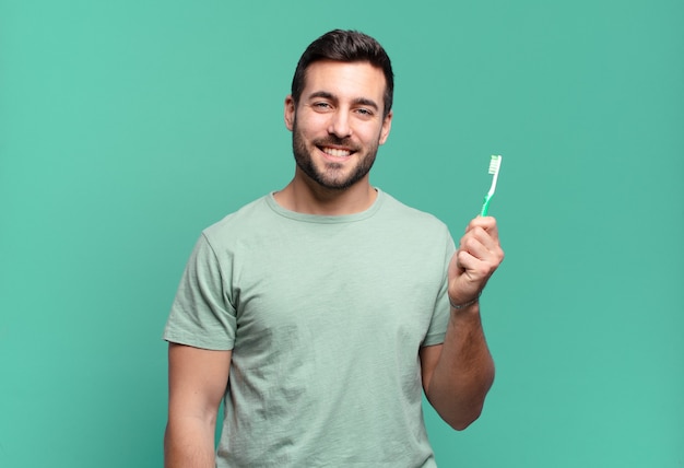 Young handsome man with a teethbrush.