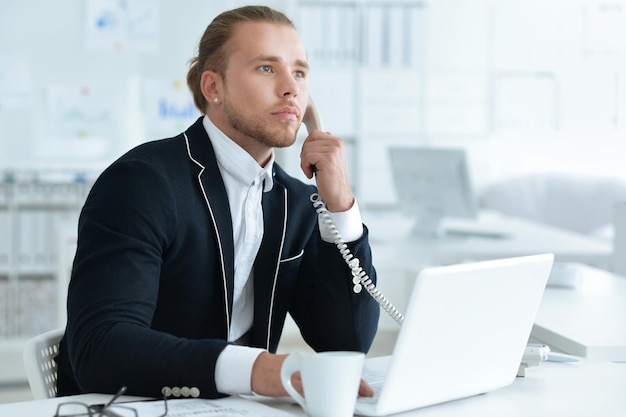 Young handsome office worker, in formal clothes