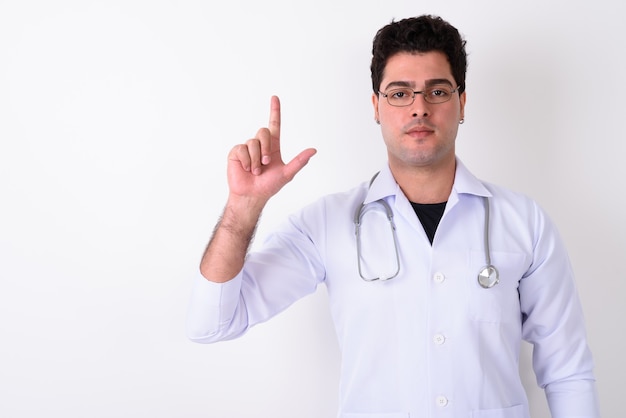 Young handsome Persian man doctor wearing eyeglasses