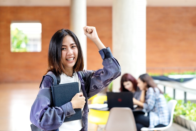 Young happy attractive asian student smiling to camera