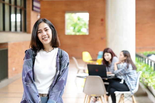 Young happy attractive asian student smiling to camera