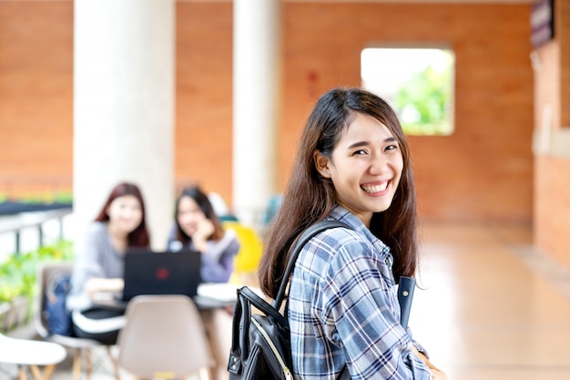 Young happy attractive asian student smiling to camera