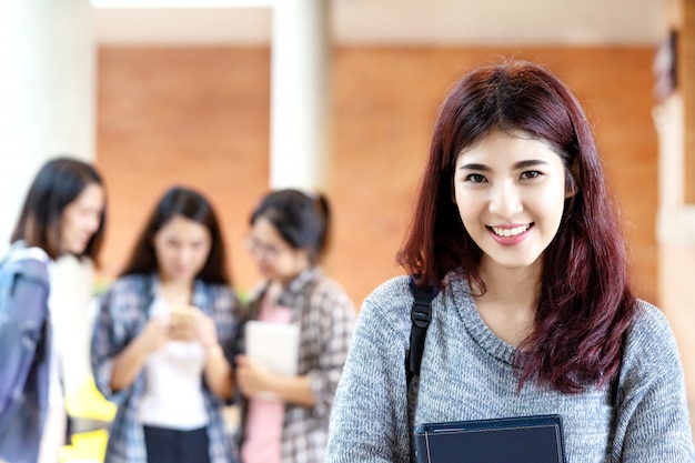 Young happy attractive asian student smiling to camera