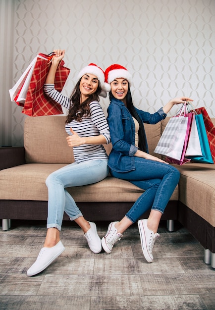 Young happy beautiful women in Santa hats