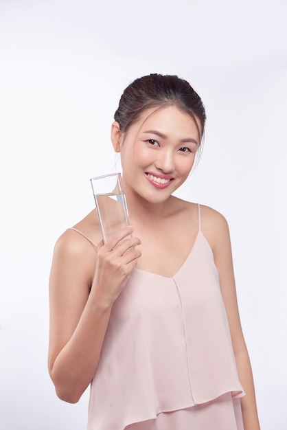 Young happy beauty healthy Asian woman holding glass water with smiley face