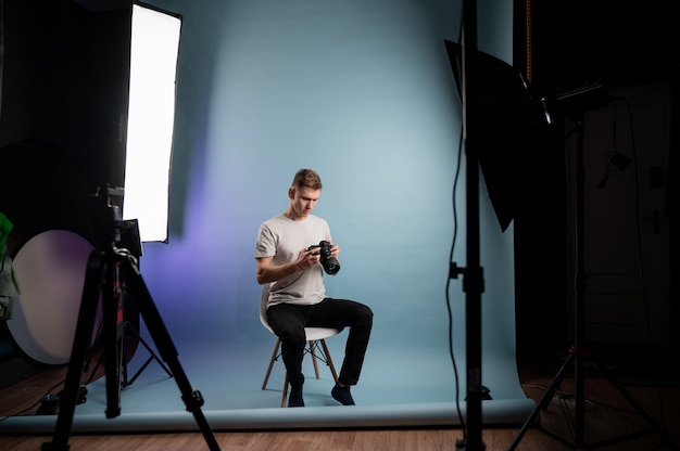 Young happy caucasian male posing in studio.Backstage concept.