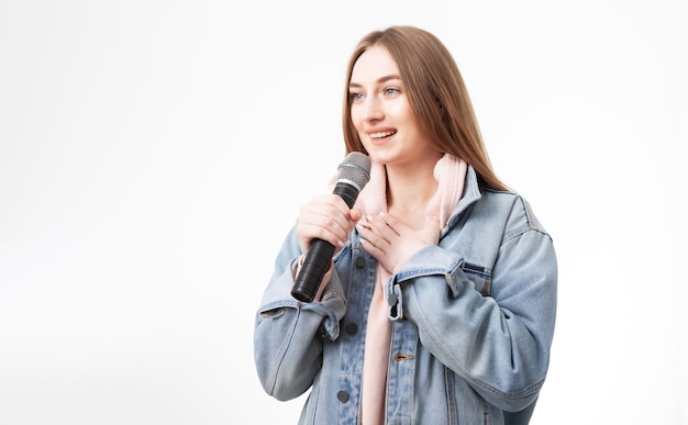 Young happy caucasian woman holding microphone isolated on white background