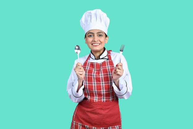 young happy chef girl white outfit having tools indian pakistani model