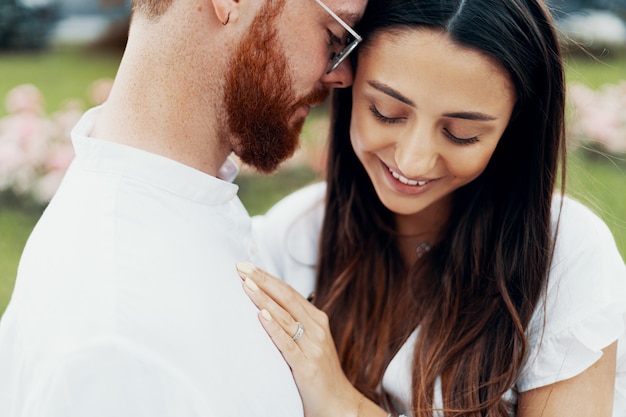 Young happy couple hugging on the city street