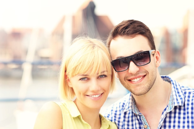 a young happy couple looking to the camera in Gdansk Marina