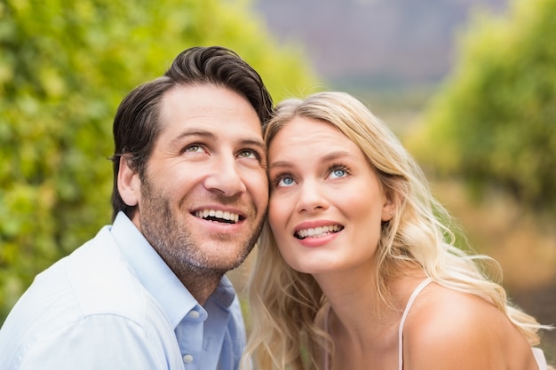 Young happy couple looking in the sky