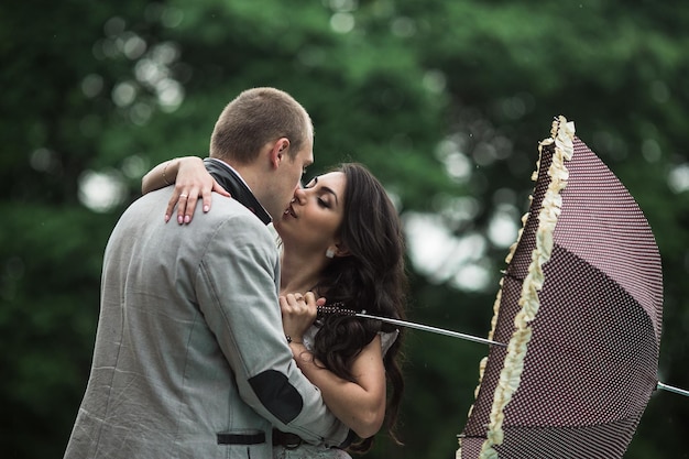 Young happy couple in love outdoors. loving man and woman on a walk in a spring blooming park