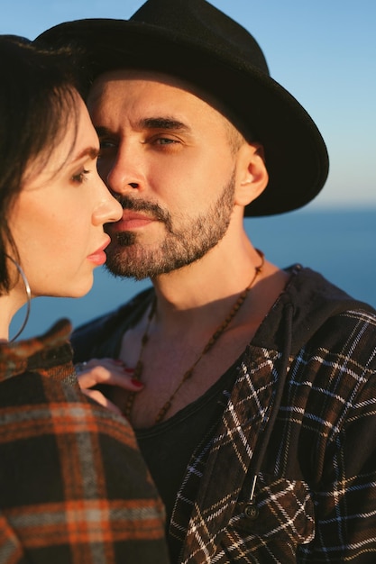 Young happy couple in love in a romantic moment when a man kisses a woman with a sea view