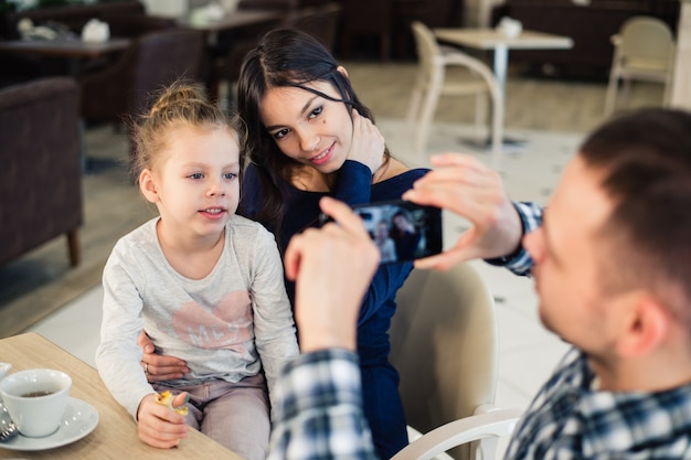 Young happy family having fun in a restaurant