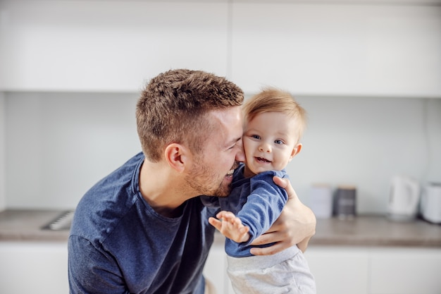 Young happy father hugging his adorable beloved son.