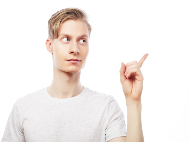 Young happy man with good idea sign in casuals looking at camera isolated on white background.