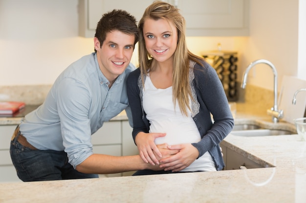 Young happy man with his pregnant wife