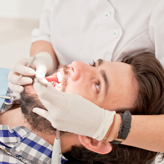 Young happy man and woman in a dental examination at dentist