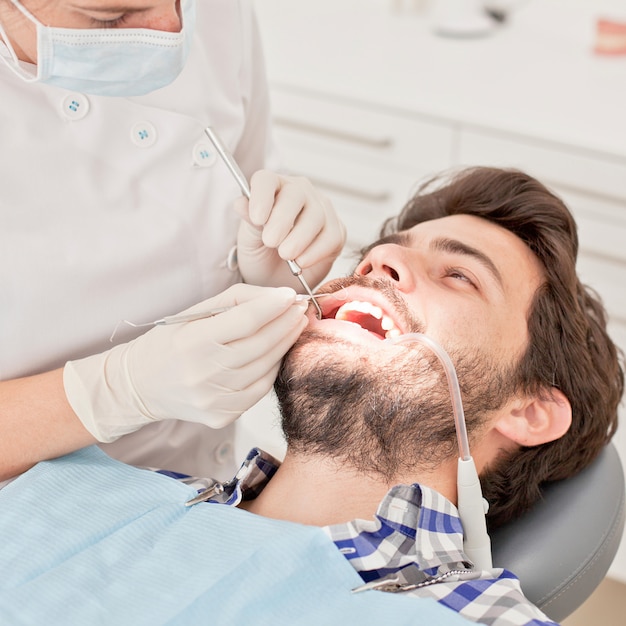 Young happy man and woman in a dental examination at dentist