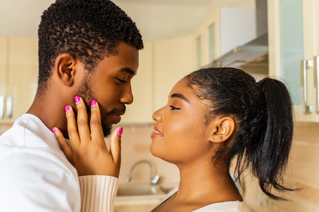 Young happy mixed race couple spending their time at home in the kitchen